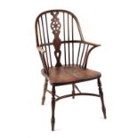 A Glenister Windsor wheel-back elbow chair, with turned legs united by a crinoline stretcher.