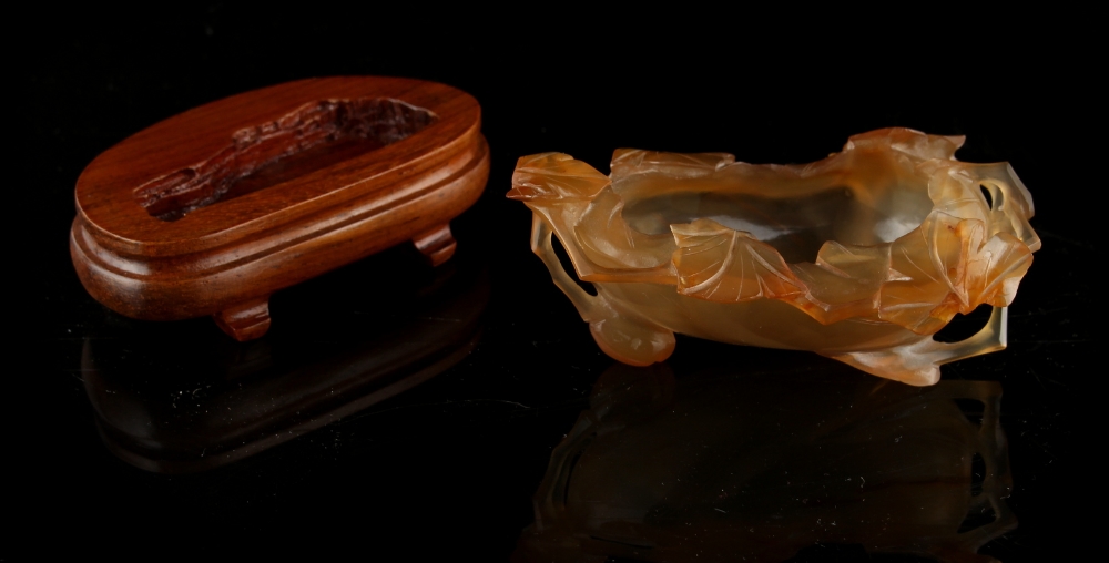 A Chinese agate leaf brushwasher, 3.7ins. (9.4cms.) long, with later associated hardwood stand. - Image 2 of 2