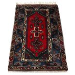 Property of a gentleman - an Anatolian woollen hand-made carpet with red & blue ground, 79 by 51ins.