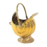 Property of a gentleman - a Victorian brass shell form coal scuttle.