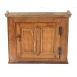 An 18th century elm wall cupboard with twin fielded panelled door, 31.5ins. (80cms.) wide.