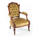 Property of a lady - a Victorian carved walnut & button upholstered armchair, with black china