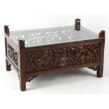 Property of a gentleman - a modern Chinese carved low table, with glass inset top, 35.5ins. (90cms.)