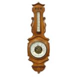 Property of a gentleman - a late 19th / early 20th century carved oak cased aneroid barometer &