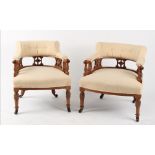 Property of a lady - a pair of late Victorian carved walnut tub chairs, with brown china castors (