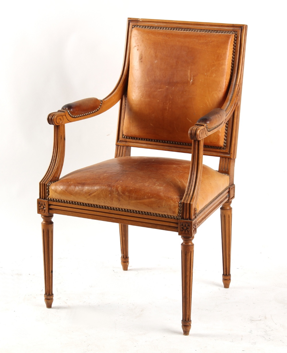 Property of a deceased estate - a Louis XVI style tan leather upholstered open armchair.