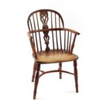 Property of a gentleman - a mid 19th century elm seated yew wood Windsor elbow chair with turned