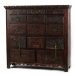 Property of a deceased estate - a carved oak cabinet with an arrangement of fourteen drawers, 52ins.