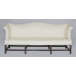 Property of a lady - a George III mahogany camel back sofa, with later cream upholstery, on square