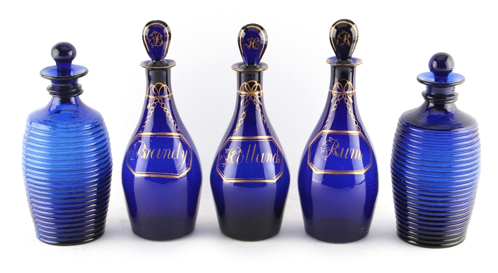 Property of a gentleman - a set of three Georgian 'Bristol' blue glass spirit decanters with lozenge