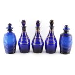 Property of a gentleman - a set of three Georgian 'Bristol' blue glass spirit decanters with lozenge