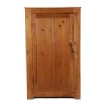 Property of a deceased estate - a pine cupboard with fielded panelled door enclosing four shelves,
