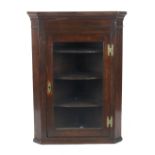 Property of a deceased estate - a George III oak corner wall cabinet with glazed door enclosing