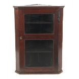 Property of a deceased estate - a George III oak corner wall cabinet with glazed door enclosing