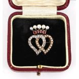 An early 20th century Belle Epoque ruby diamond & pearl twin heart brooch with coronet over, 23mm