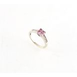 Property of a lady - a 9ct white gold ring set with four square cut pink stones, possibly