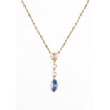 A yellow gold sapphire & diamond pendant on chain necklace, the oval cut clear vibrant blue sapphire