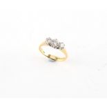 Property of a lady - an 18ct yellow gold diamond three stone ring, the round brilliant cut
