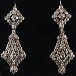 An attractive pair of Georgian diamond pendant earrings, the variously shaped diamonds in rub-over