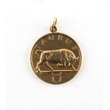 Property of a gentleman - an 18ct yellow gold Taurus pendant medallion, approximately 7.4 grams.
