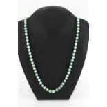 Property of a lady - an early 20th century Chinese jadeite bead necklace, the largest of the