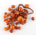 Property of a lady - an amber graduated oval bead necklace, requires re-stringing, approximately