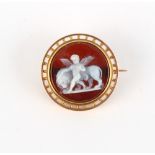 A yellow gold circular agate cameo brooch, the well carved stone modelled as a cherub & lion, 26mm