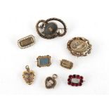 Property of a lady - eight mourning brooches, one dated 1822, another 1891, the largest 42mm long (