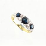 An 18ct yellow gold sapphire & diamond ring, the three oval cushion cut sapphires weighing a total