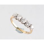 An unmarked yellow gold diamond five stone ring, the five round brilliant cut diamonds weighing an