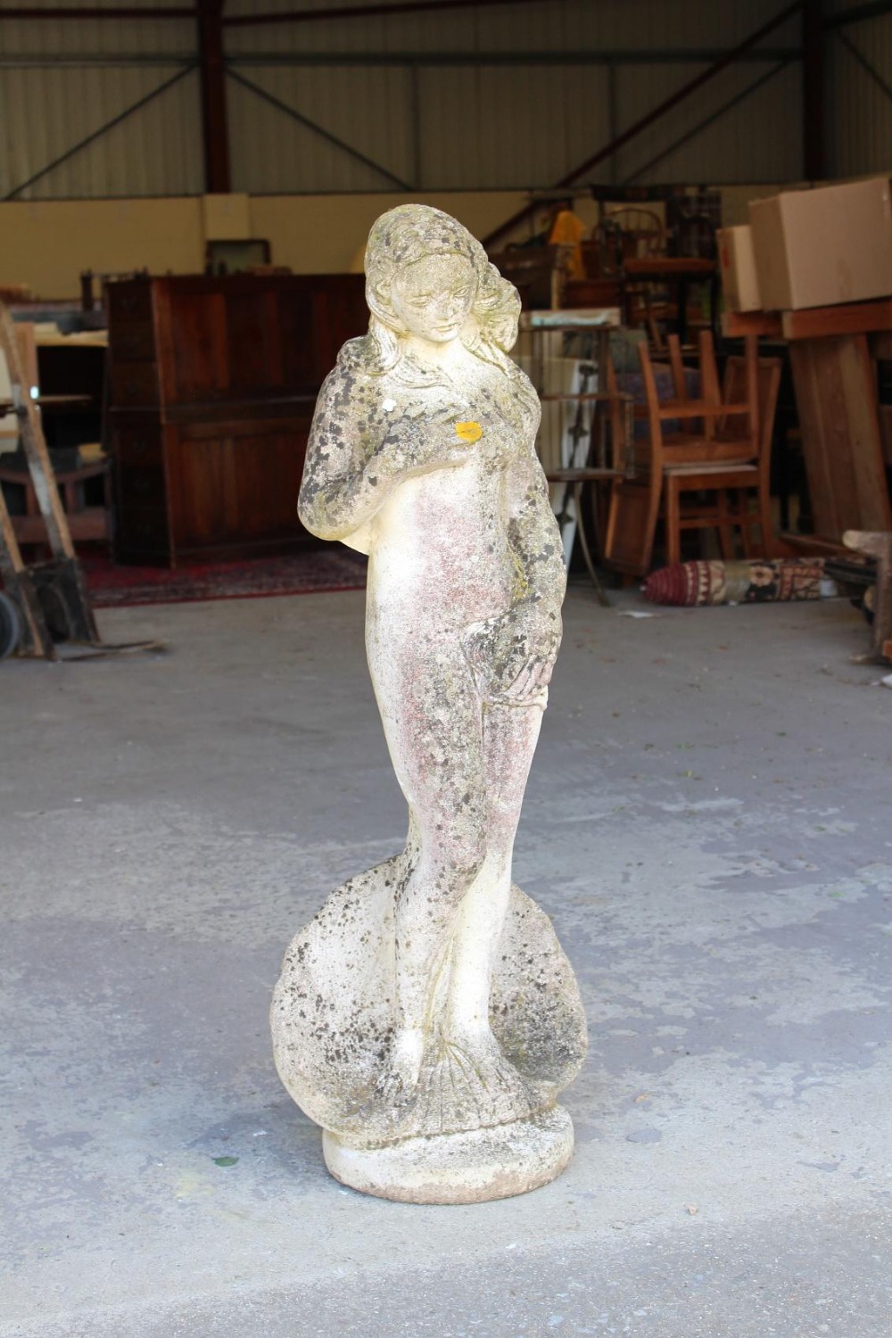 Property of a deceased estate - a well weathered reconstituted stone garden figure of Venus,