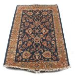 Property of a lady - a Persian woollen hand-made rug, with navy ground, 73 by 47ins. (186 by