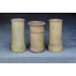 Property of a deceased estate - a pair of buff coloured chimney pots, 24ins. (61cms.) high; together