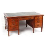Property of a lady - an Edwardian mahogany desk with leather inset top above seven drawers & two