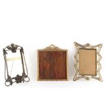 Property of a lady - an Art Nouveau brass easel photograph frame, 9.5ins. (24cms.) high; together