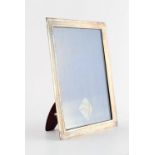 Property of a lady - an early 20th century silver rectangular easel photograph frame, with red