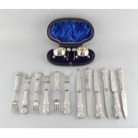 Property of a gentleman - a set of six each Edwardian silver ornate handled dessert knives &