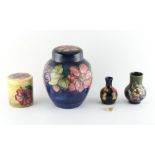 Property of a gentleman - four Moorcroft items, comprising two covered jars, the taller with