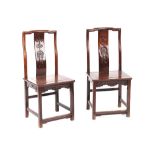 A pair of Chinese hongmu side chairs, late 19th century, the backs carved with a bat above twin fish