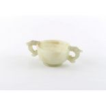 Property of a deceased estate - a Chinese carved pale celadon jade two handled cup, late Qing