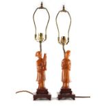Property of a lady - a pair of Chinese carved amber style figures of ladies, mounted as table lamps,
