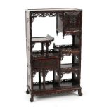 A late 19th century Chinese carved hongmu display cabinet of small size, fitted with a door, a