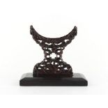 A Chinese zitan bi disc stand, 19th century, carved with five bats, 6.25ins. (16cms.) high.