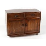 Property of a deceased estate - an Ercol elm side cabinet with two drawers above two doors,