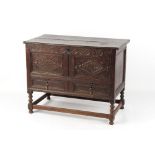 Property of a gentleman - a carved oak mule chest, parts 18th century, the hinged top above two