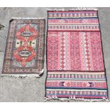 Property of a lady - a flat weave rug, 74 by 43ins. (188 by 109cms.); together with another rug (2).
