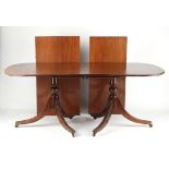 Property of a deceased estate - a solid mahogany twin pillar dining table with two extra leaves,