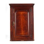 Property of a gentleman - a late 18th century George III oak & mahogany corner wall cabinet, the