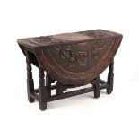 Property of a lady - an 18th century oak oval topped gate-leg table with later carved decoration,