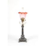 A Victorian variegated marble paraffin oil lamp with cut glass reservoir & pink tinted petal